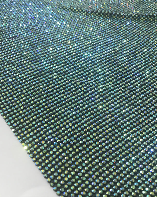 Close-up of emerald AB crystal mesh fabric with 2mm crystals in black casing