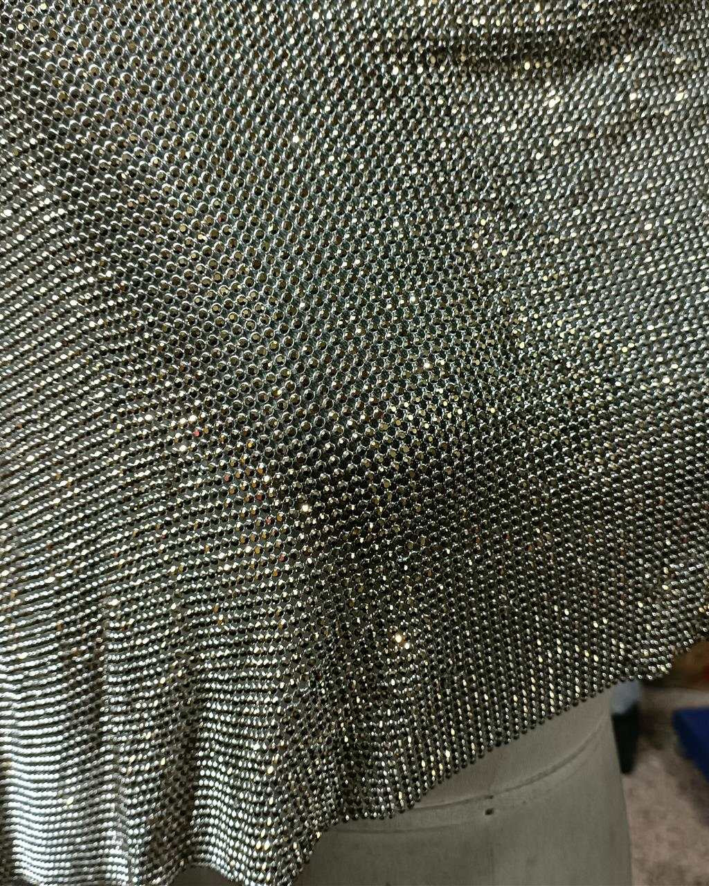 Close-up of aurum ab crystal mesh fabric with 2mm crystals in silver casing