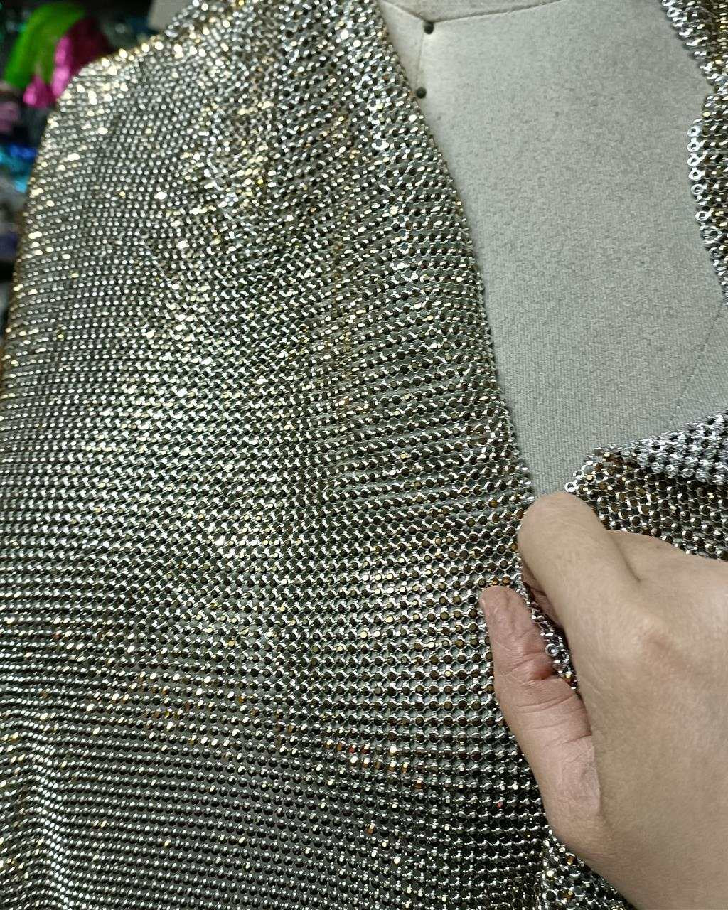 Close-up of aurum ab crystal mesh fabric with 2mm crystals in silver casing