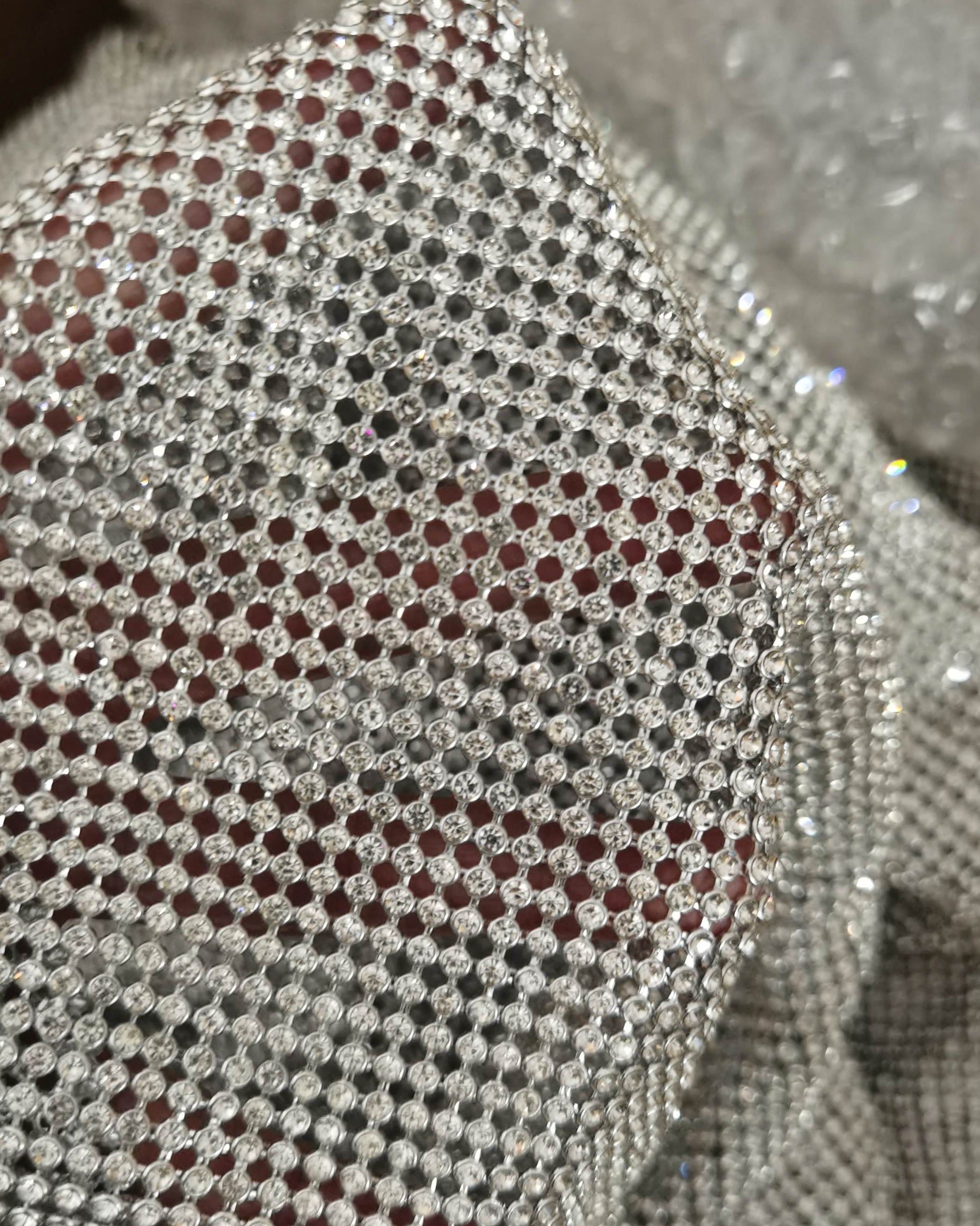 close up of a crystal mesh silver fabric made with glass rhinestones