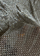 A luxurious chainmail silver platinum fabric adorned with high-quality, dazzling silver rhinestones, creating a stunning and radiant surface