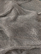 close up of a crystal mesh silver fabric made with glass rhinestones