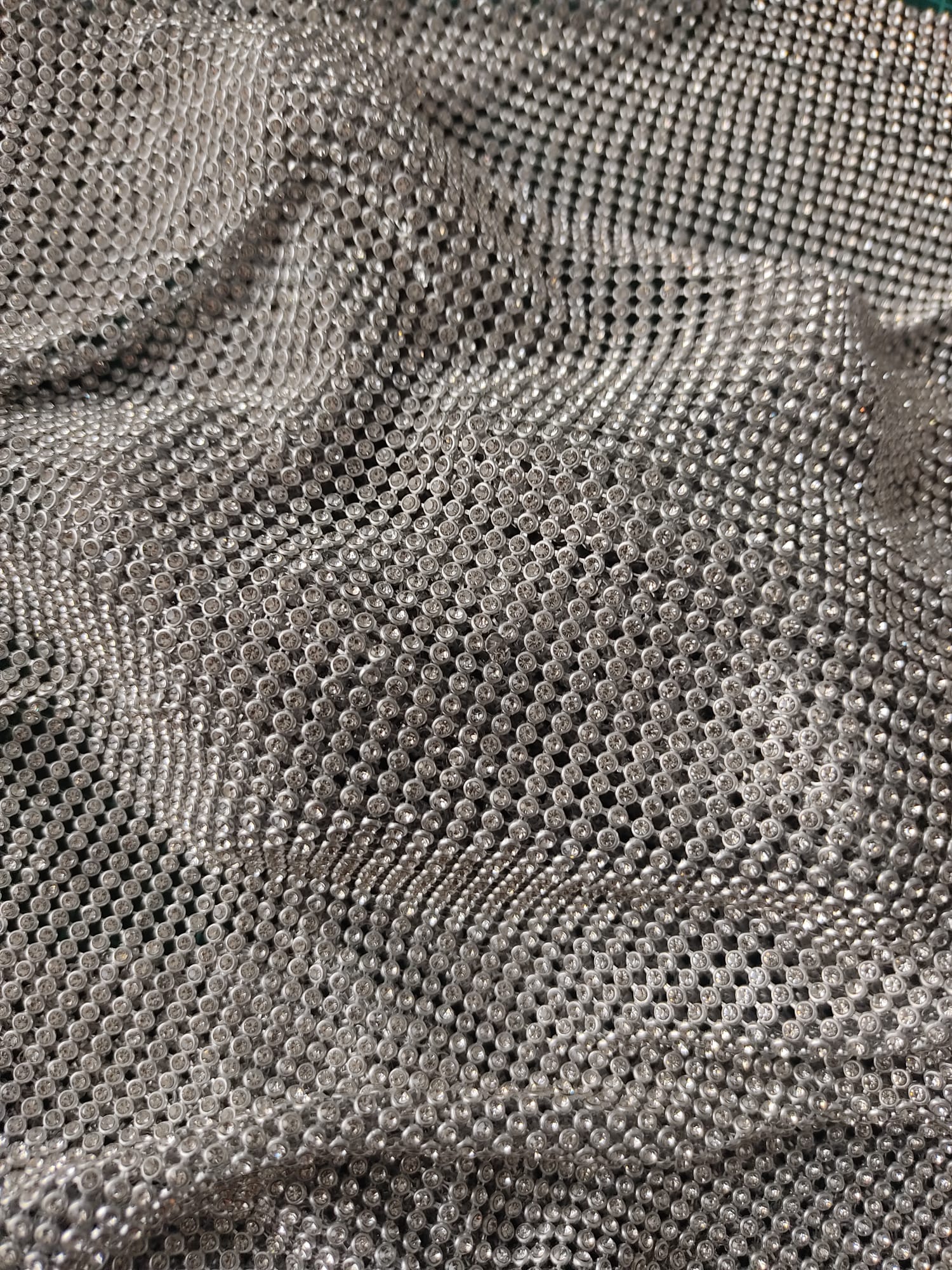 close up of a crystal mesh silver fabric made with glass rhinestones